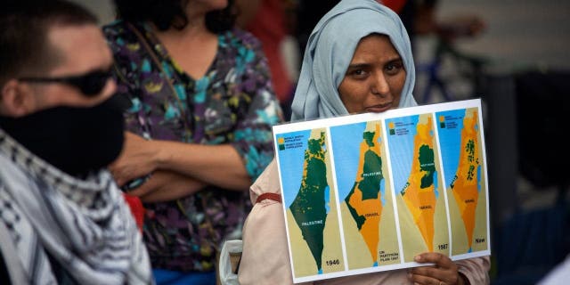A woman holds a map of Palestine from 1946 to 2020. Supporters of Palestine organized a gathering in Toulouse against the planned annexation of parts of West Bank and the total annexation of the Jordan Valley by Netanyahu government on July 1, 2020.