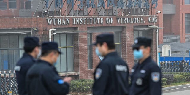 Security personnel stand guard outside the Wuhan Institute of Virology in Wuhan, China, on Feb. 3, 2021.