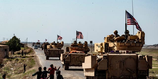 US Bradley Fighting Vehicles (BFV) patrol in the Suwaydiyah oil fields in Syria's northeastern Hasakah province on February 13, 2021. 