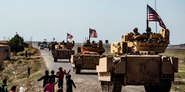 U.S. Bradley Fighting Vehicles (BFV) patrol in the Suwaydiyah oil fields in Syria's northeastern Hasakah province on February 13, 2021. 