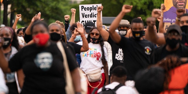 People march following the guilty verdict in the trial of Derek Chauvin on April 20, 2021, in Atlanta, Georgia. 
