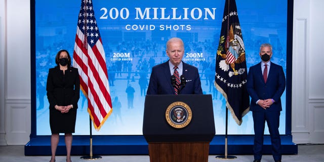 Vice President Kamala Harris, left, and White House COVID-19 response coordinator Jeff Zients, right, listen while President Biden speaks about COVID-19 response and the state of vaccinations in the South Court Auditorium at the White House complex on April 21, 2021 in Washington, D.C.