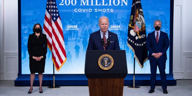 Vice President Kamala Harris, left, and White House COVID-19 response coordinator Jeff Zients, right, listen while President Biden speaks about COVID-19 response and the state of vaccinations in the South Court Auditorium at the White House complex on April 21, 2021 in Washington, D.C.