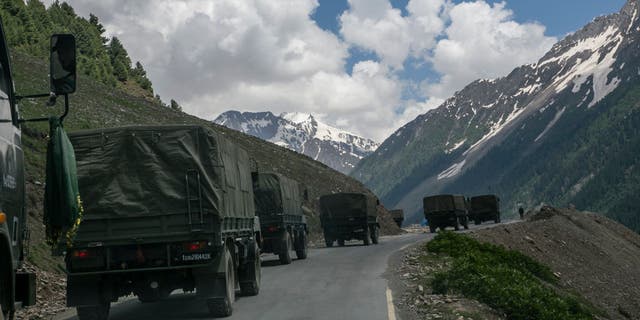 An Indian army convoy carrying reinforcements and supplies travels toward Leh through Zoji La, a high mountain pass bordering China June 13, 2021, in Ladakh, India.