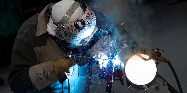 A worker demonstrates cutting a pipe at the Plumbers and Gasfitters Local 5 Training Facility on Aug. 4, 2021, in Lanham, Maryland.