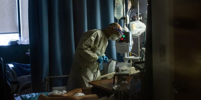 A doctor checks on a COVID-19 patient at Providence Cedars-Sinai Tarzana Medical Center in Tarzana, California, on Sept. 2, 2021.