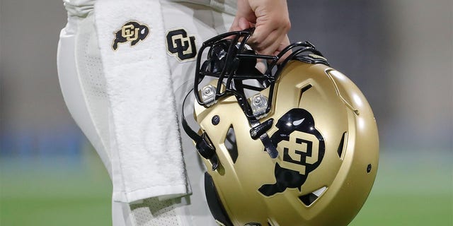 A Colorado Buffaloes player holds up his helmet before a game against the Arizona State Sun Devils at Sun Devil Stadium in Tempe, Arizona on September 25, 2021.
