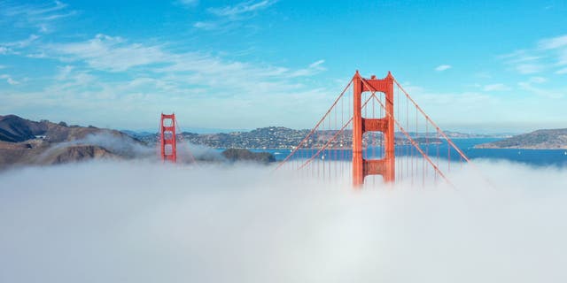 An aerial view of the Golden Gate Bridge is seen with fog in San Francisco, California, on October 29, 2021.