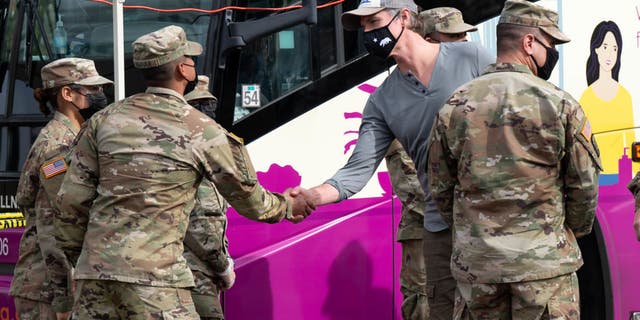 Gov. Gavin Newsom greets members of the National Guard on hand to help out at a mobile testing site in Paramount, California.