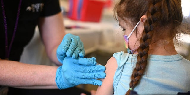 A nurse administers a pediatric dose of the COVID-19 vaccine to a young girl. Dr. Marc Siegel noted that since fewer hospitalizations are occurring with current COVID subvariants, they are actually less severe, though health professionals are not sure why this is.