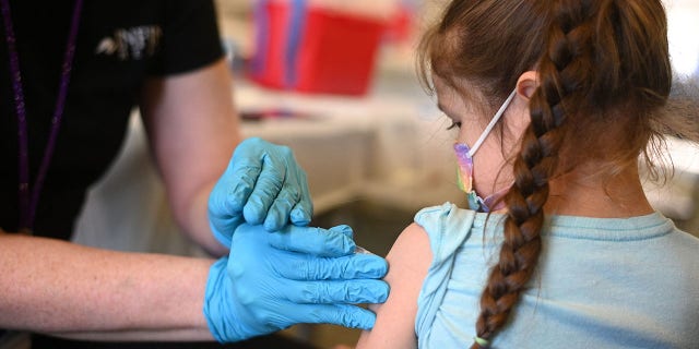 A nurse administers a pediatric dose of the COVID-19 vaccine to a young girl. Dr. Marc Siegel noted that since fewer hospitalizations are occurring with current COVID subvariants, they are actually less severe, though health professionals are not sure why this is.