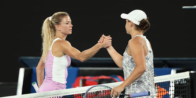 Camila Giorgi shakes hands with Ashleigh Barty after their match at Australian Open in Melbourne, Jan. 21, 2022.