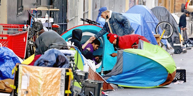 Homeless people use illegal drugs at a camp along Willow Street in the Tenderloin neighborhood of San Francisco on February 24, 2022.