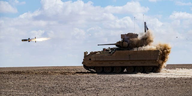A US Bradley Fighting Vehicle (BFV) fires an AGM-114 Hellfire during a heavy-weaponry military exercise with troops from the Syrian Democratic Forces (SDF) Special Operations in the countryside of Deir Ezzor in northeastern Syria, on March 25, 2022. 