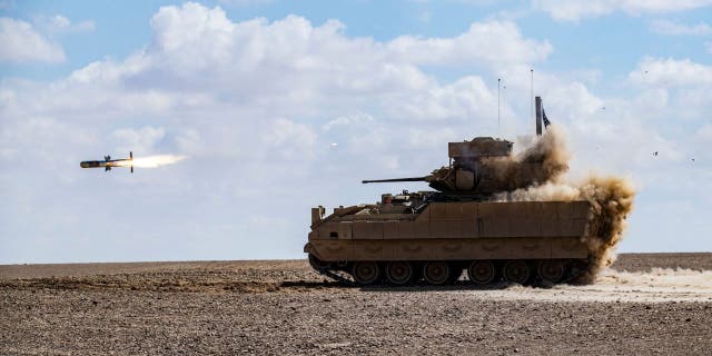 A US Bradley Fighting Vehicle (BFV) fires an AGM-114 Hellfire during a heavy-weaponry military exercise with troops from the Syrian Democratic Forces (SDF) Special Operations in the countryside of Deir Ezzor in northeastern Syria, on March 25, 2022. 