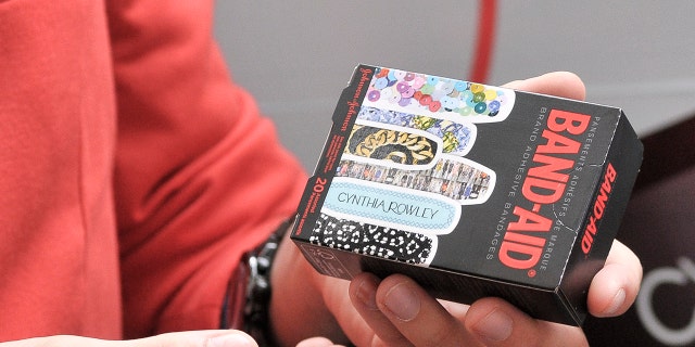 Meet the American who invented Band-Aids 5 An individual holds a Band-Aid box during the BAND-AID's Fashion Week Glamulance on Sept. 8, 2011, in New York City.