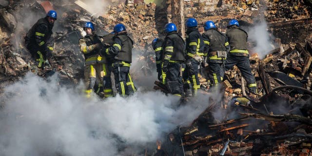 Ukrainian rescuers work at the site of a residential building destroyed by a Russian drone strike, which local authorities consider to be Iranian-made unmanned aerial vehicles Shahed-136, in central Kyiv, Ukraine, Oct. 17, 2022.