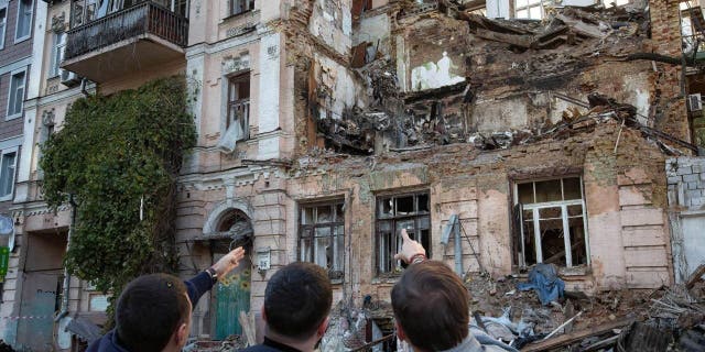 People look at the residential building destroyed by a Russian drone strike. At least four people have been killed as a result of a drone attack on a residential building in Kyiv, Ukraine on the morning of October 17, 2022. 