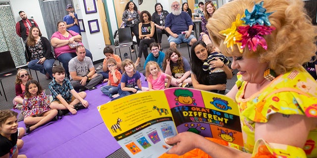 Rich Kuntz, also known as Gidget, reads to children during Drag Queen Story Hour on March 21, 2019.