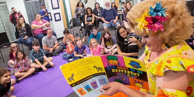 Rich Kuntz, also known as Gidget, reads to children during Drag Queen Story Hour on March 21, 2019.