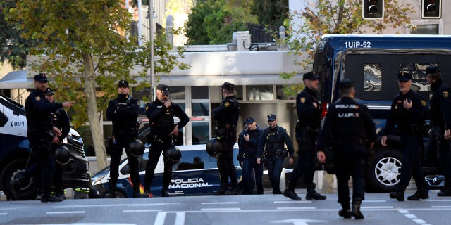 Spanish police stand guard near the US embassy in Madrid, on December 1, 2022, after they have received a letter bomb, similar to one which went off at the Ukrainian embassy.