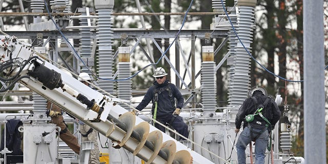 Crews in Carthage work to restore power to tens of thousands in Moore County, North Carolina, after an attack at two Duke Energy substations in December. 