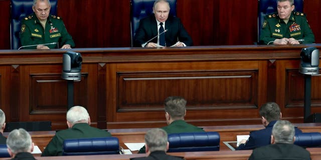 President Vladimir Putin and Gen. Valery Gerasimov, right, attend an expanded meeting of the Russian Defense Ministry Board in Moscow, on Dec. 21, 2022.