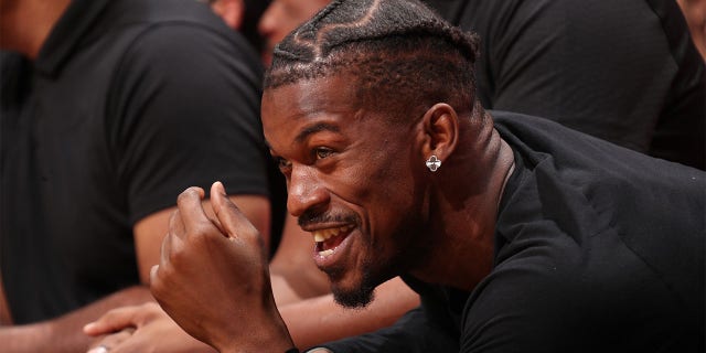 Miami Heat's Jimmy Butler laughs on the sidelines during a game against the Minnesota Timberwolves on December 26, 2022 at FTX Arena in Miami, Florida. 