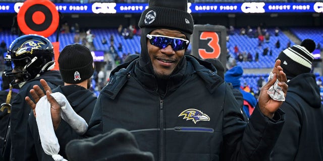 Quarterback Lamar Jackson stands on the sidelines, cheering on his teammates during the Ravens' 17-9 win over the Atlanta Falcons on December 24, 2022.