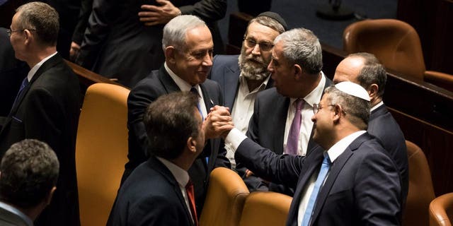 Israeli Prime Minister Benjamin Netanyahu and State Security Minister Itamar Ben-Gubir react after the swearing-in ceremony in the Israeli parliament during the swearing-in ceremony of the new government in the Israeli parliament on December 29, 2022 in Jerusalem To do.