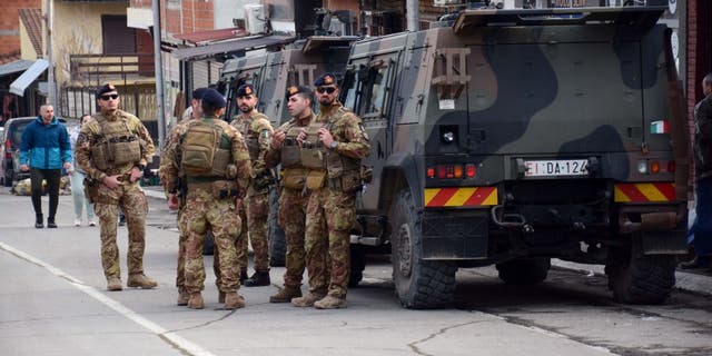 Soldiers of the NATO-led Kosovo Force patrol near a road barricade set up in the city of Mitrovica, Kosovo, on Dec. 29, 2022.