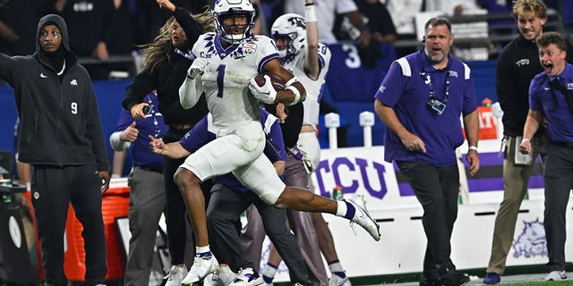 TCU Horned Frogs wide receiver Quentin Johnston runs with the ball in the game against the Michigan Wolverines during the Vrbo Fiesta Bowl at State Farm Stadium in Glendale, Arizona on December 31, 2022.