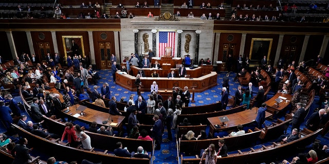 Members talk on the floor of the House Chamber on the opening day of the 118th Congress on Tuesday, Jan. 3, 2023, at the U.S. Capitol in Washington, D.C. 