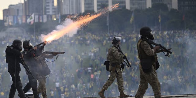 Supporters of former President Jair Bolsonaro supporters clash with security forces as they raid the National Congress in Brasilia, Brazil, Jan. 8, 2023.