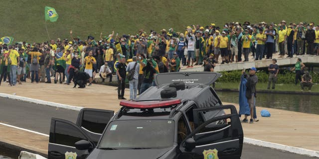 A view of damaged police car as supporters of former President Jair Bolsonaro clash with security forces after raiding the National Congress in Brasilia, Brazil, Jan. 8, 2023.