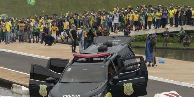 A view of damaged police car as supporters of former President Jair Bolsonaro clash with security forces after raiding the National Congress in Brasilia, Brazil, 08 January 2023. (Joedson Alves/Anadolu Agency via Getty Images)