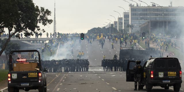 Supporters of former President Jair Bolsonaro clash with security forces as they raid the National Congress in Brasilia, Brazil, Jan. 8, 2023.