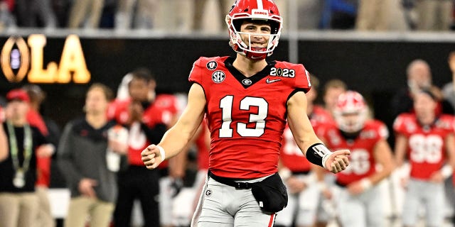 Quarterback Stetson Bennett #13 of the Georgia Bulldogs reacts after a touchdown against the TCU Horned Frogs in the first half in the CFP National Championship Football game at SoFi Stadium in Inglewood on Monday, January 9, 2023. 