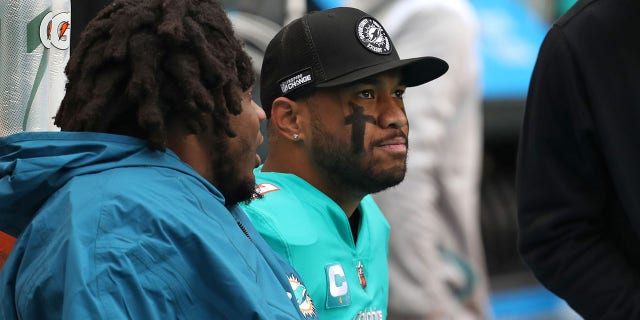 Dolphins quarterback Tua Tagovailoa sits on the bench against the Packers at Hard Rock Stadium on December 25, 2022 in Miami Gardens.