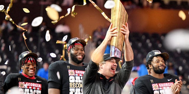 Head coach Kirby Smart of the Georgia Bulldogs celebrates with the trophy after winning the CFP national championship against the TCU Horned Frogs at SoFi Stadium in Inglewood, Calif., Monday, Jan. 9, 2023.