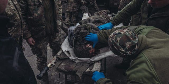 Ukrainian army medics transfer a wounded soldier in a hospital on the Donbass frontline in Donetsk, Ukraine on Jan. 12, 2023. 