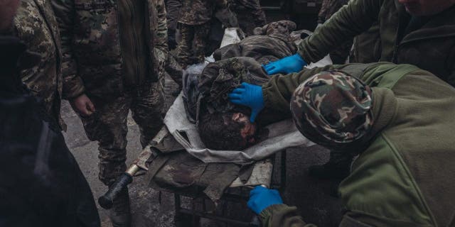 Ukrainian army medics transfer a wounded soldier in a hospital on the Donbass frontline in Donetsk, Ukraine on Jan. 12, 2023. 