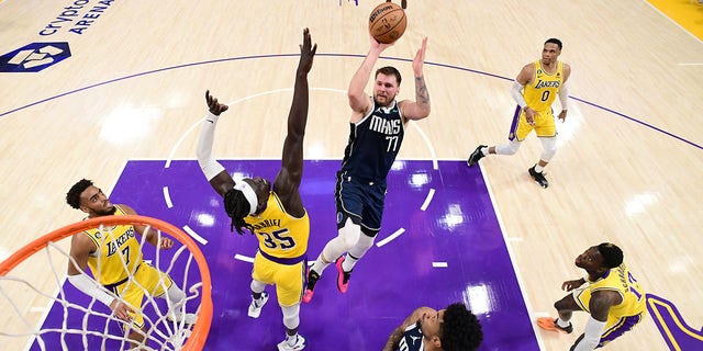 Luka Doncic, number 77 of the Dallas Mavericks, throws the ball during the game against the Los Angeles Lakers on January 12, 2023 at Crypto.Com Arena in Los Angeles.