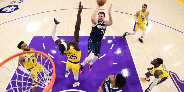 Luka Doncic, number 77 of the Dallas Mavericks, throws the ball during the game against the Los Angeles Lakers on January 12, 2023 at Crypto.Com Arena in Los Angeles.