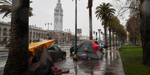 Homeless tents are seen along Embarcadero Street during heavy rain in San Francisco on January 11, 2023.