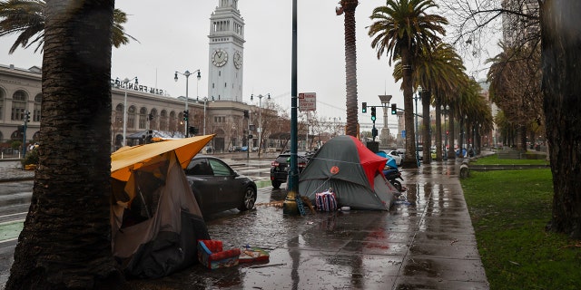 Homeless tents are seen along Embarcadero Street during heavy rain in San Francisco on January 11, 2023.