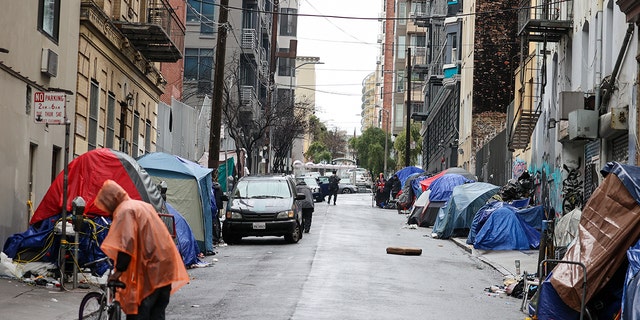 Tents and homeless people line the street near the San Francisco City Hall.