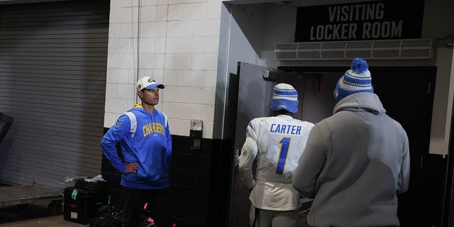 Head coach Brandon Staley stands washes in stunned silence as players file past him after losing 32-30 to the Jacksonville Jaguars in an AFC Wild Card game at TIAA Bank Field. 