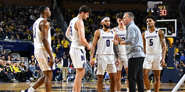 Northwestern Wildcats head coach Chris Collins talks to his team during a timeout during the Wolverines game on Sunday, Jan. 15, 2023, at Crisler Center in Ann Arbor, Michigan.