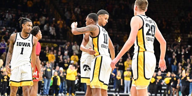 Iowa players celebrate on the court after winning a college basketball game between the Maryland Terrapins and the Iowa Hawkeyes on January 15, 2023, at Carver-Hawkeye Arena in Iowa City, IA